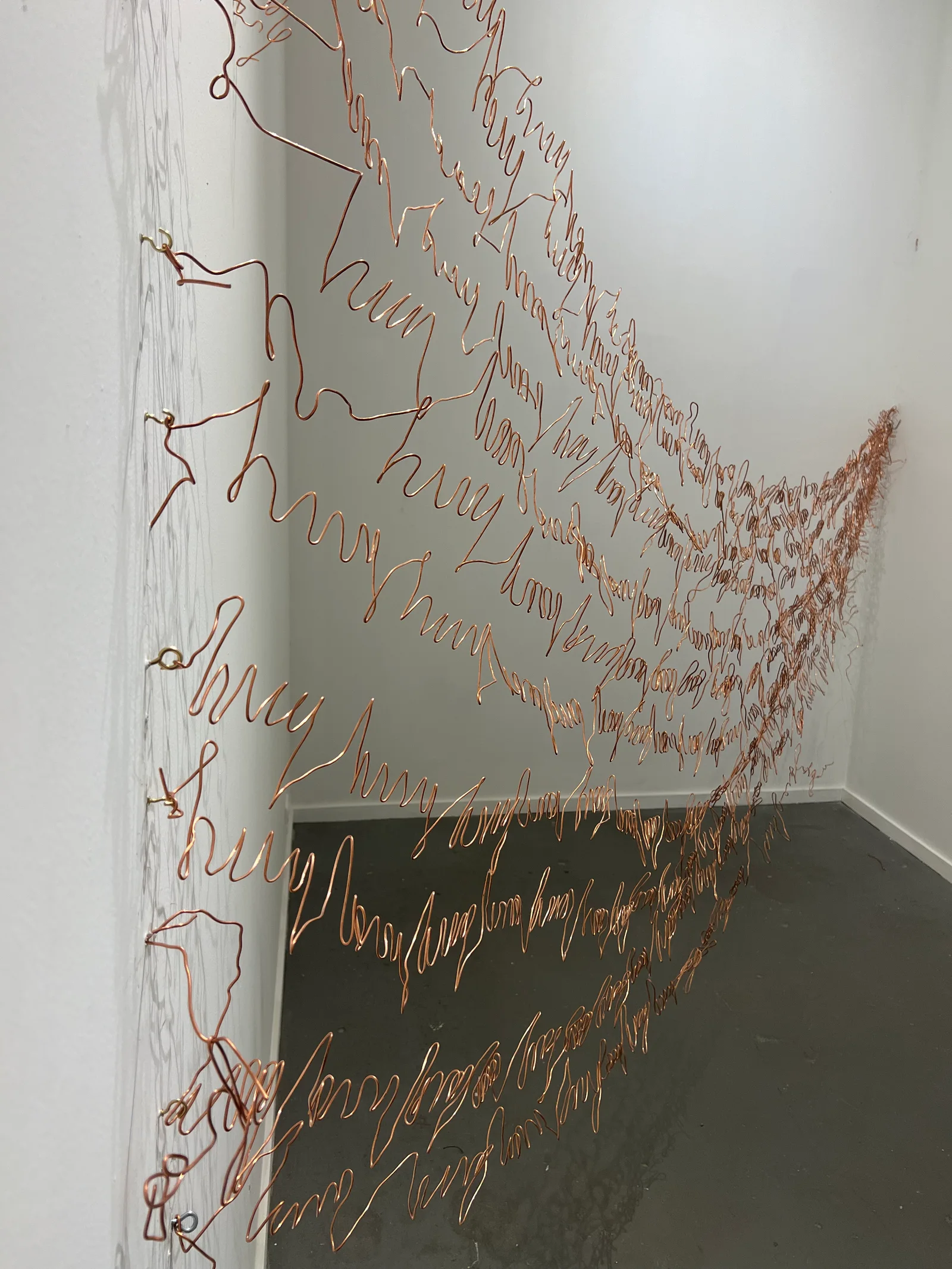 A suspended textile installation in the gallery.
