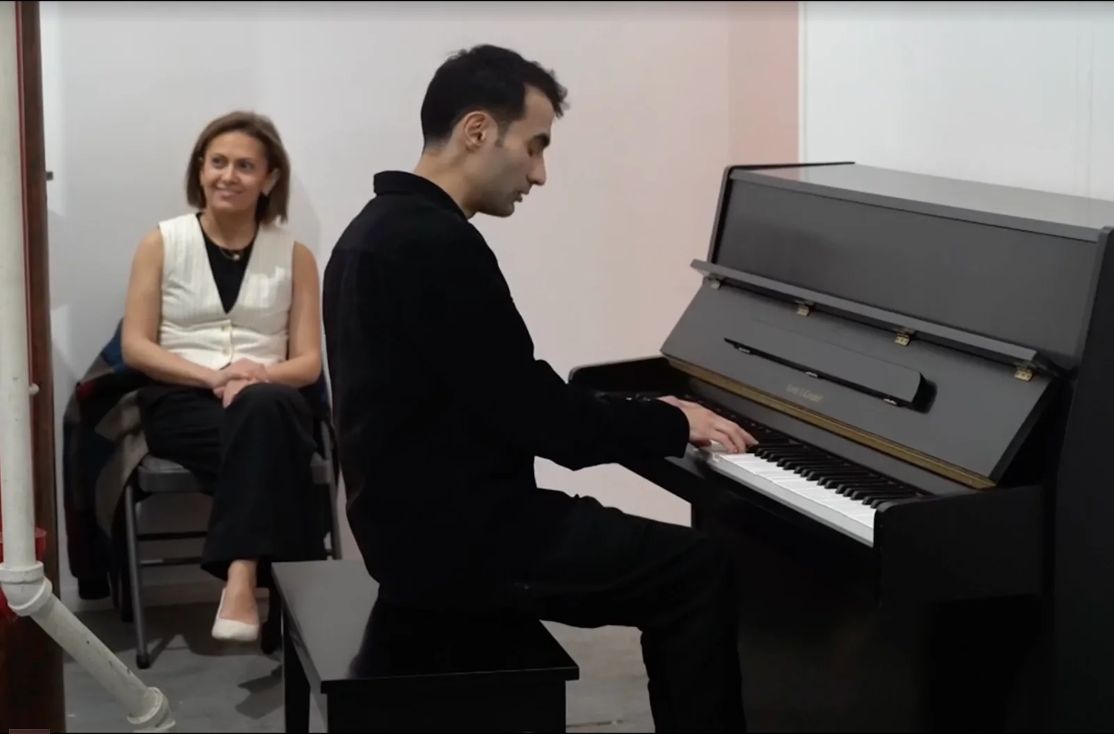 Tigran Hamasyan seated at a piano with Tamar Hovsepian nearby.